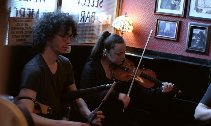 a man and woman playing music in a bar