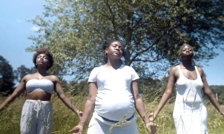 Backwards God still 3 women in white with hands outstretched
