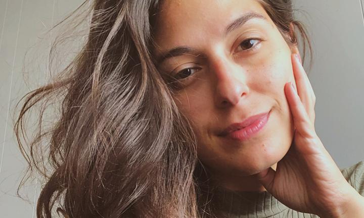 poet Gabriella Balza with hand on side of face