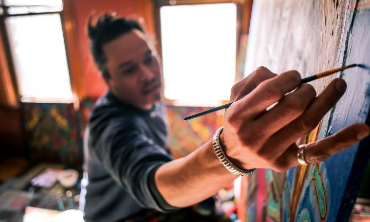 Richie Morales in his studio painting