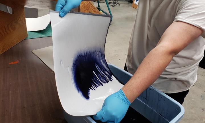 ArtWorking artist hand dying paper