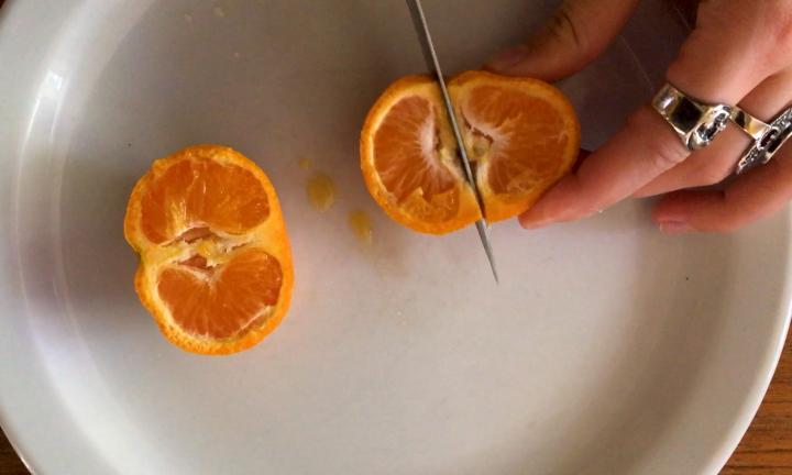 hands cutting tangerines Rotten Fruit Midwest Video Poetry Fest
