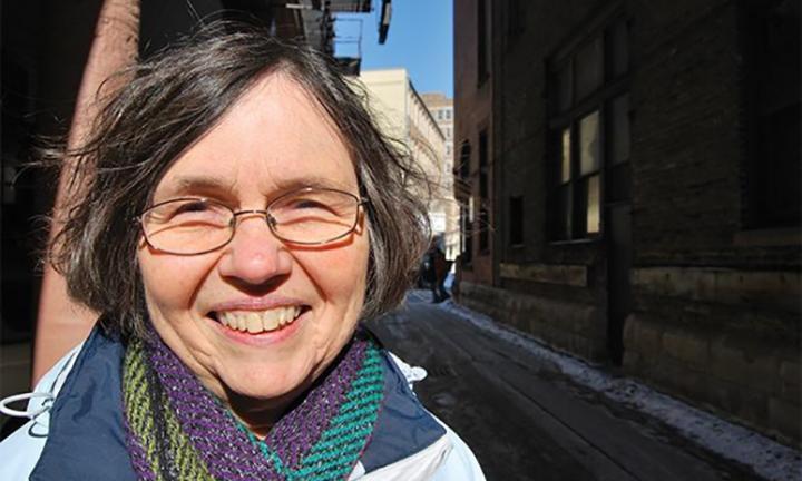 Poet Margaret Rozga standing outside in the street