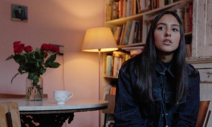 a young woman at a table with roses