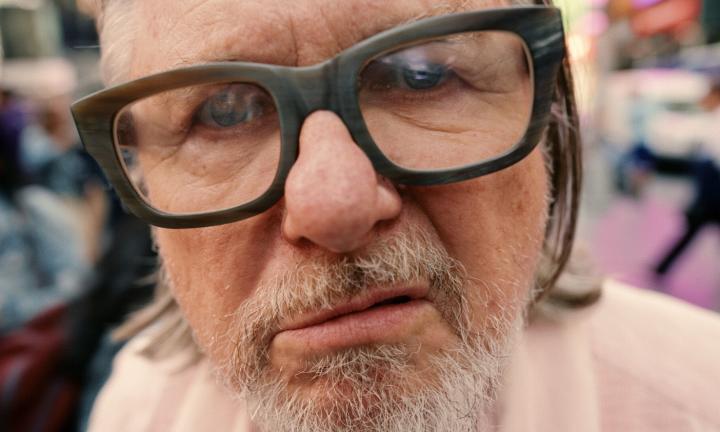 Close-Up shot of man with large classes and graying beard.