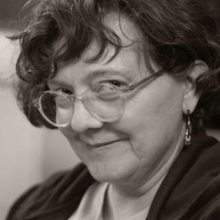 Poet Marnie Dresser with clear glasses smiling