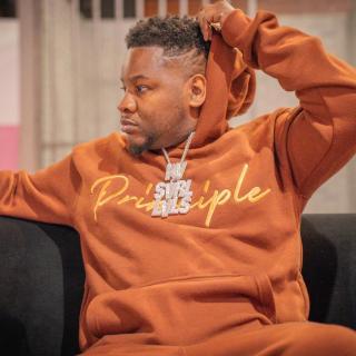 Photo of author in dark orange hoodie with large chain that says his name