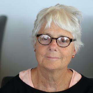 Poet Ronnie Hess in tortoiseshell glasses