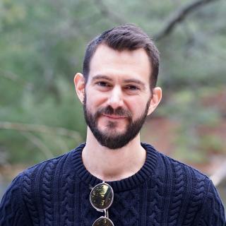 Poet Philip Matthews in blue sweater with sunglasses