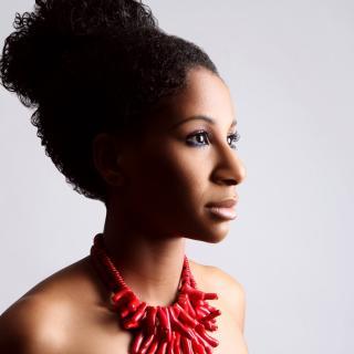 picture of Alison Rollins with hair pulled back and a red necklace