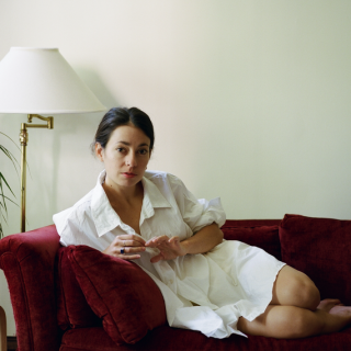 Lia Kohl sitting on a red couch
